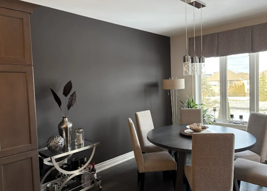 Dining room with a freshly painted dark accent wall