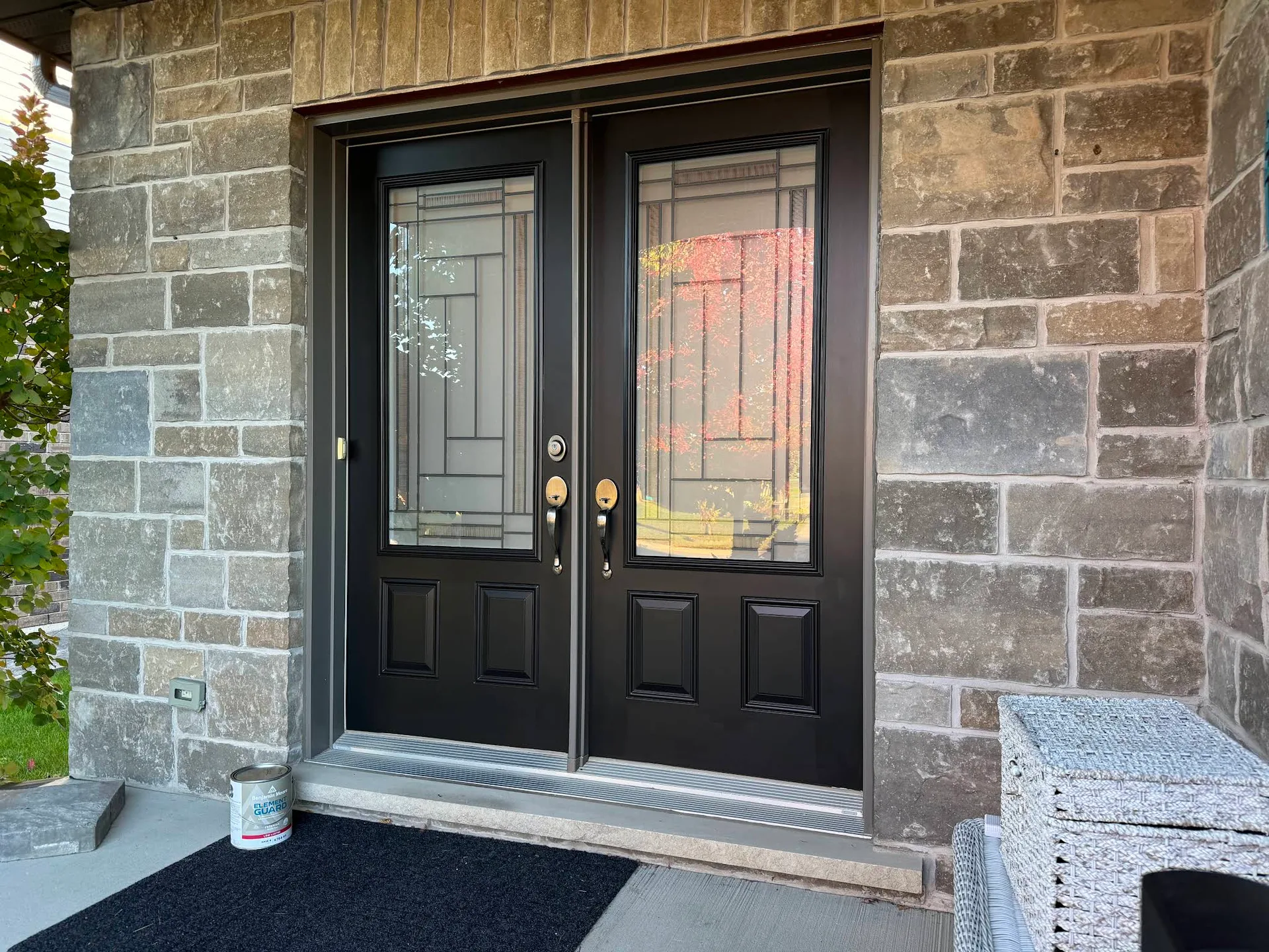 Black double entry doors with fresh paint and crisp white trim