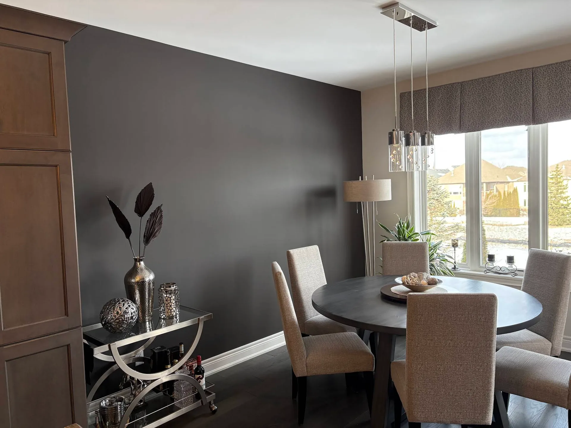 Dining room with a charcoal feature wall and bright trim