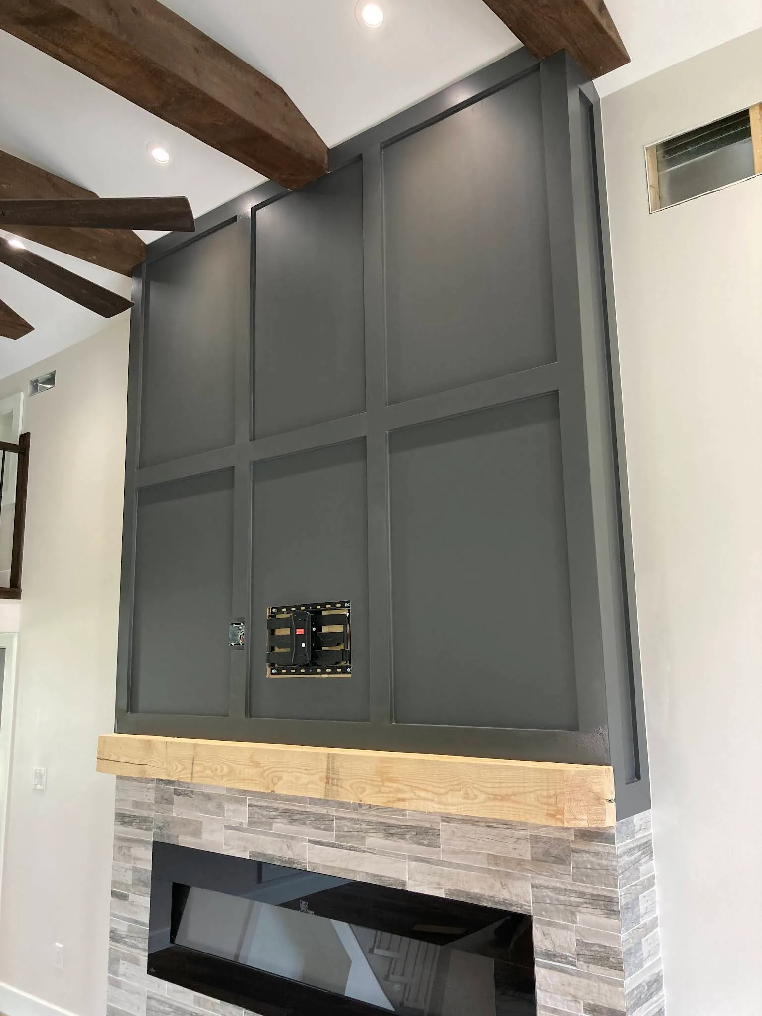Built-in fireplace surround with dark painted panel detail