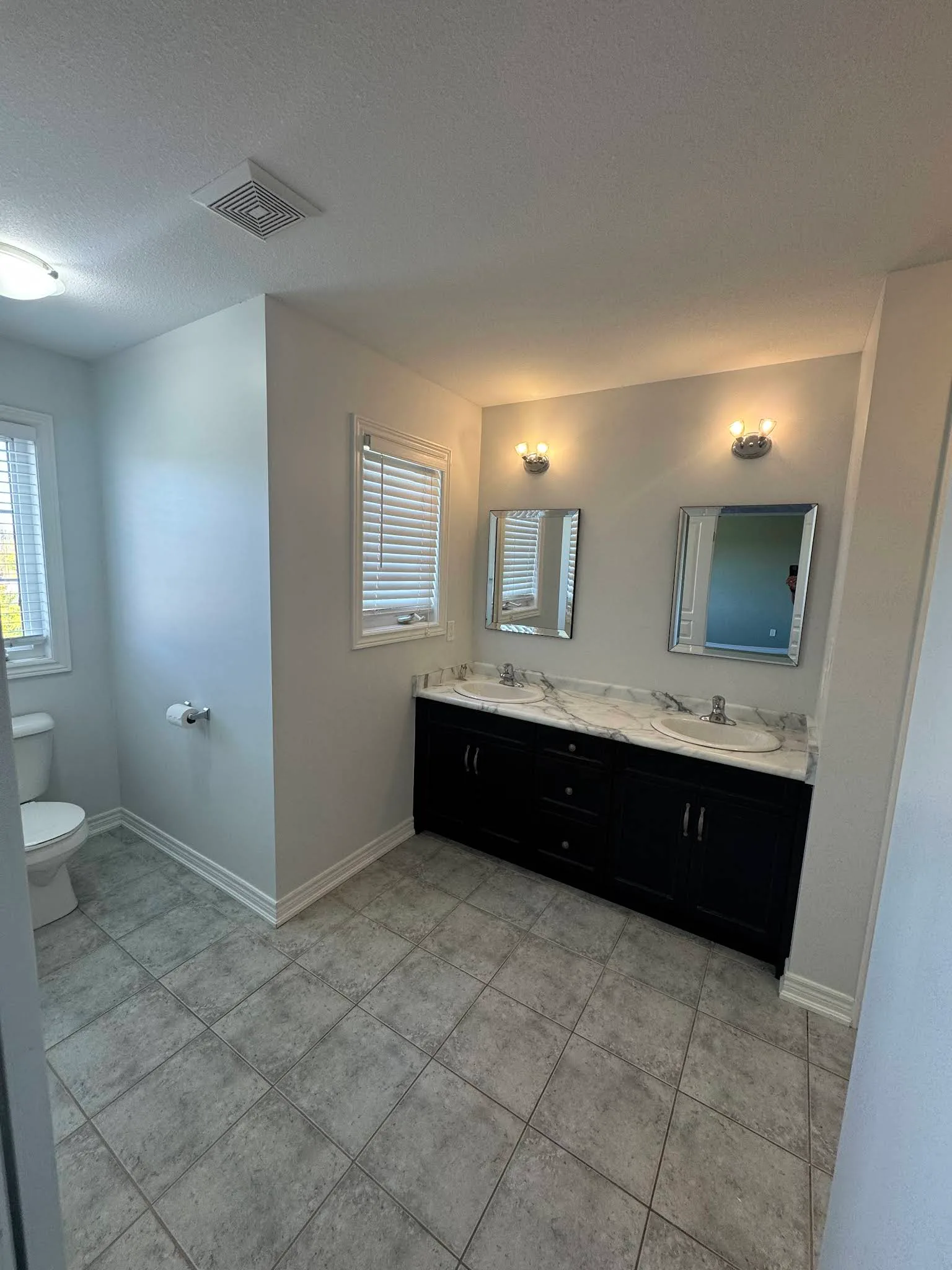 Bathroom vanity area finished in a light neutral paint colour