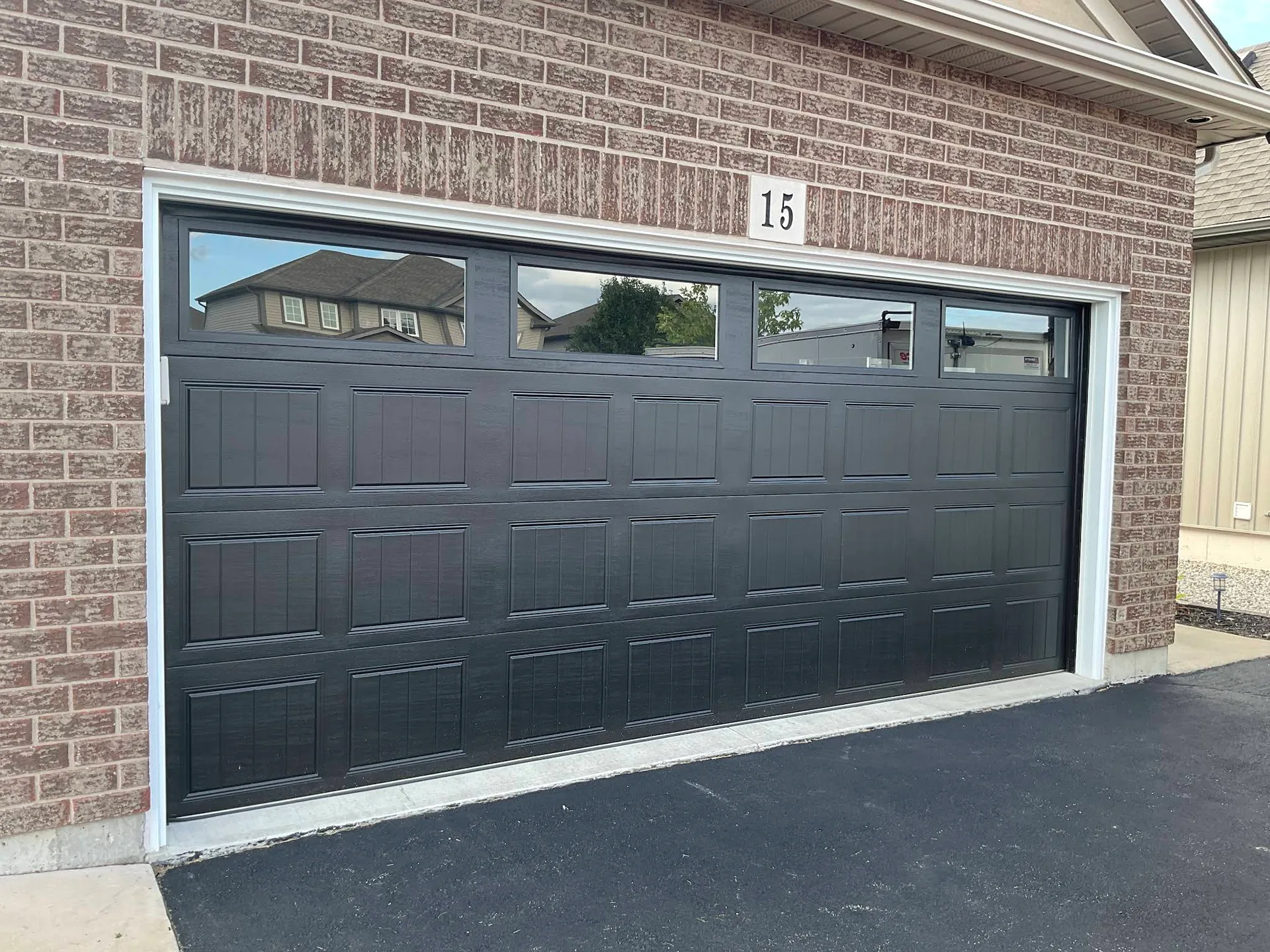 Double garage door freshly painted in charcoal grey