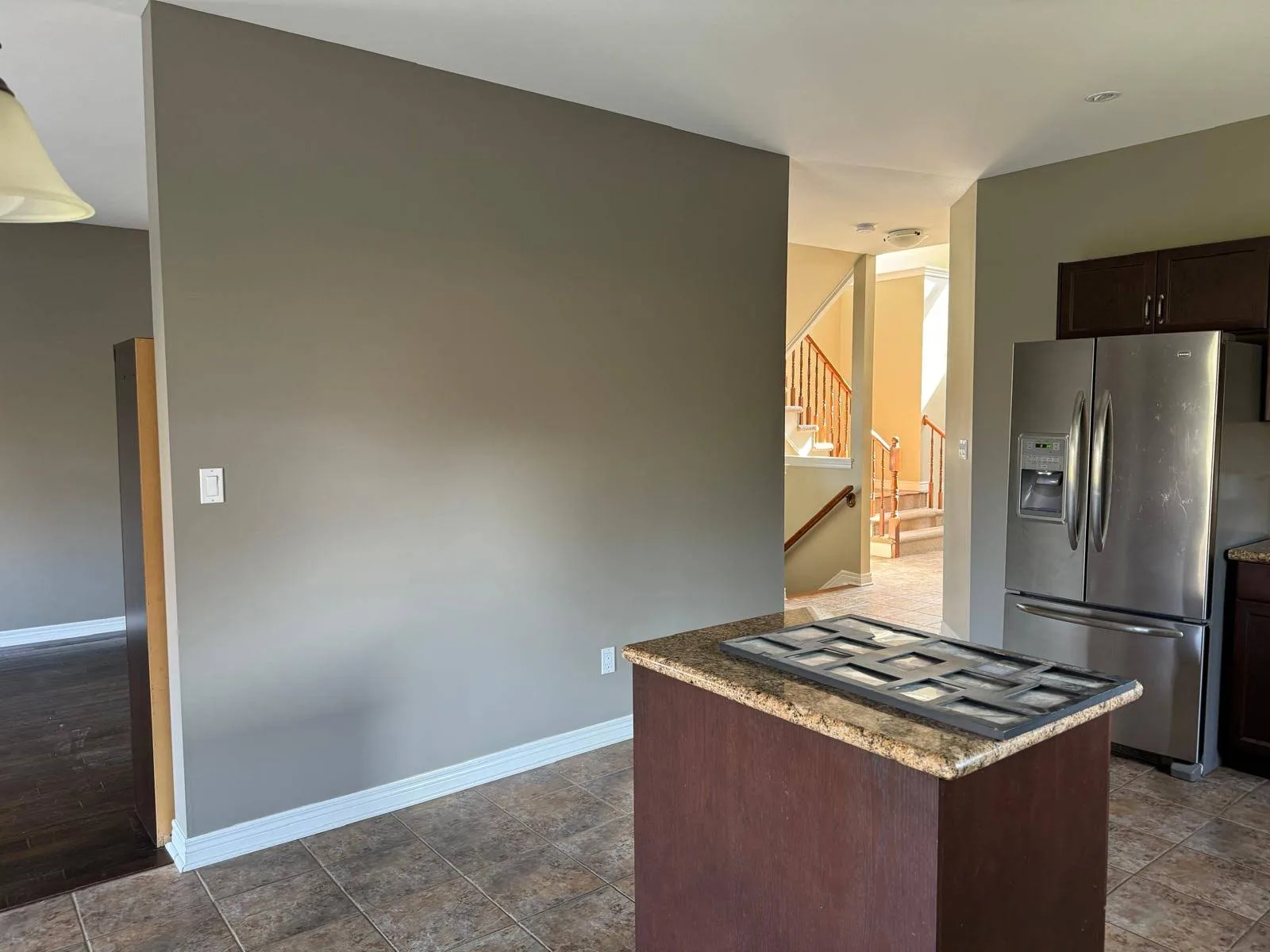 Kitchen wall freshly painted in a cool medium grey