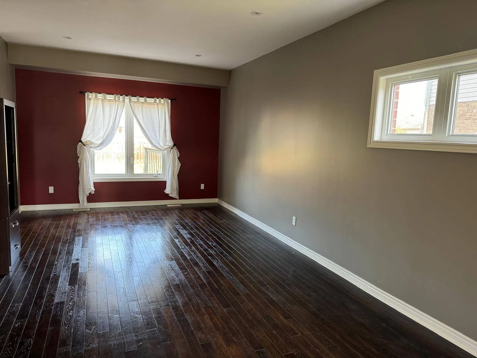Living and dining room with burgundy and grey painted walls