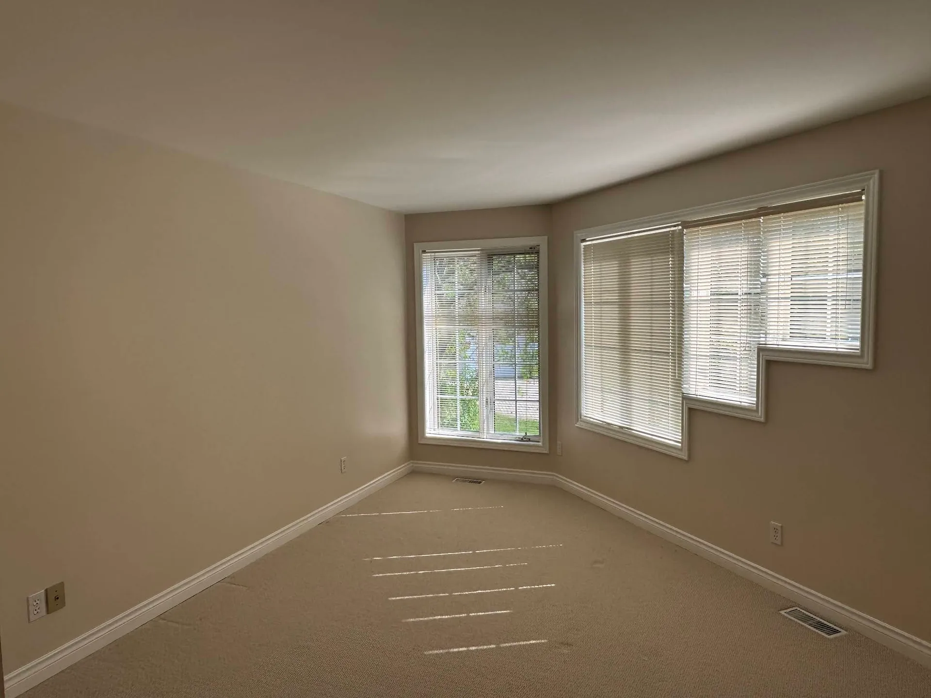 Bright living room finished with warm neutral walls and white trim
