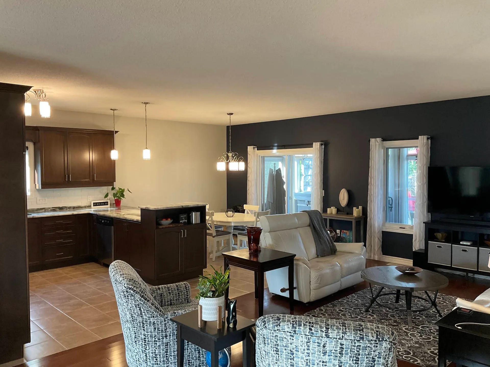 Open concept kitchen and living room with charcoal feature walls