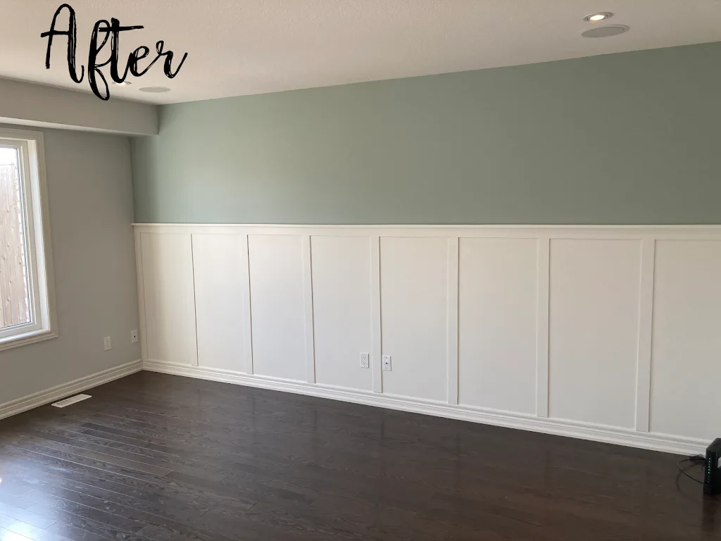 White wainscoting and baseboards beneath a soft green wall